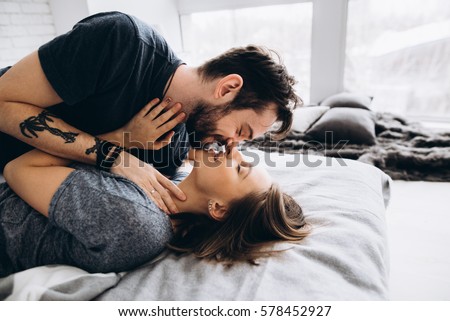 Couple Kissing And Hugging On Bed Couple Kissing And Hugging On Bed