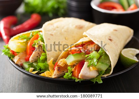 mexican tortilla wrap with chicken breast and vegetables - stock photo