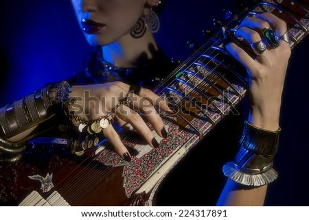 Beautiful young indian woman in traditional clothing with sitar and ...