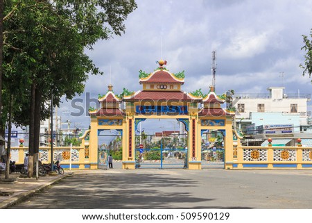 TAY NINH, VIETNAM - October 23, 2016:Gate of Cao Dai temple area and meditating followers of the Cao Dai religion in the temple Cao Dai
