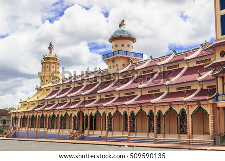 TAY NINH, VIETNAM - October 23, 2016:Cao Dai temple area and meditating followers of the Cao Dai religion in the temple Cao Dai