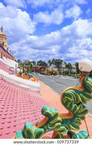 TAY NINH, VIETNAM - October 23, 2016:roof of Cao Dai temple area and meditating followers of the Cao Dai religion in the temple Cao Dai