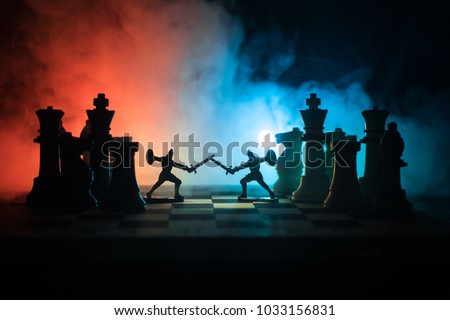 Medieval battle scene with cavalry and infantry on chessboard. Chess board game concept of business ideas and competition and strategy ideas Chess figures on a dark background with smoke and fog.