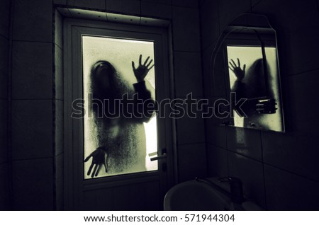 Horror woman in window wood hand hold cage scary scene halloween concept Blurred silhouette of witch Horror woman in window wood hand hold cage scary scene halloween concept Blurred silhouette of witch
