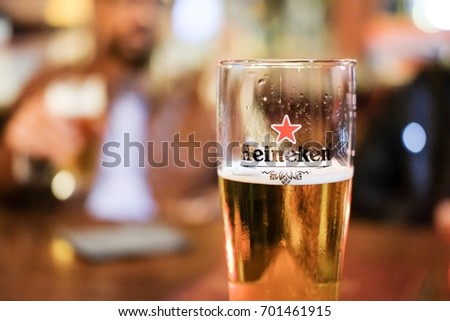 Edinburgh, United Kingdom - 22 August 2017: A Pint Glass of Heineken, Lager Beer produced by the Dutch brewing company. It is well known for its signature green bottle and red star.