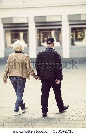 https://thumb7.shutterstock.com/display_pic_with_logo/1660264/330142715/stock-photo-an-elderly-couple-is-walking-in-the-streets-they-walk-hand-in-hand-like-couples-do-image-taken-330142715.jpg