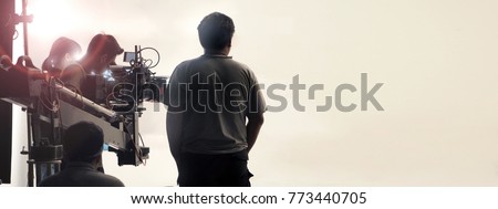 Behind the scenes of video shooting production crew team and professional camera equipment in studio.