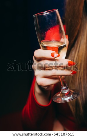 Girl holding a glass of champagne. A glass of champagne. Glass.