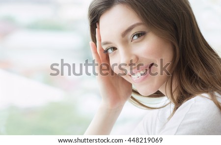 Beauty smiling model with natural make up and long eyelashes. Youth and skin care concept. Spa and wellness. Make up, long hair and lashes. Close up, selective focus.