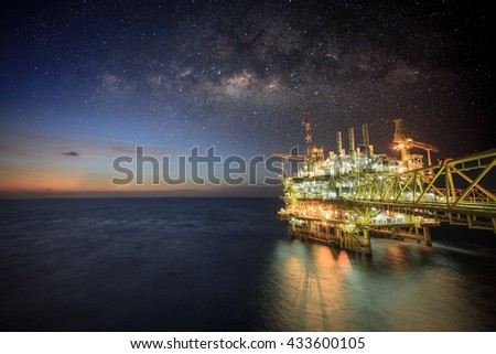 Offshore construction platform for production oil and gas, Oil and gas industry and hard work, Production platform and operation process by manual and auto function. Milky way background and galaxy.
