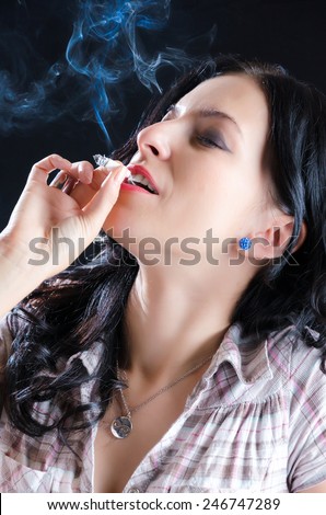https://thumb7.shutterstock.com/display_pic_with_logo/1707076/246747289/stock-photo-attractive-woman-smoking-a-cannabis-joint-against-a-black-background-246747289.jpg