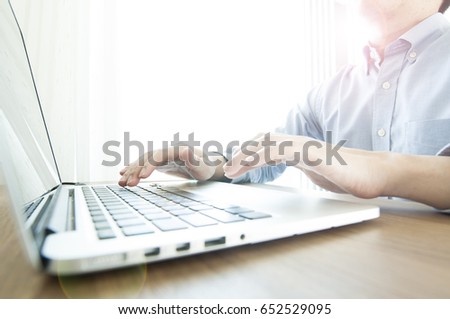 Business man typing keyboard in front of laptop screen