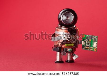 Retro style robot character with chip board. Computer accessories toy mechanism, funny black helmet head on red background. Copy space, macro view