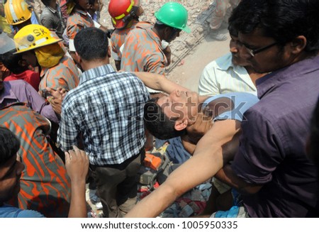 DHAKA, BANGLADESH - APRIL 24, 2013: Rescue workers try rescue trapped garment workers in the Rana plaza building which collapsed in Saver near Dhaka, Bangladesh on April 24, 2013.