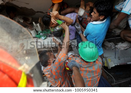 DHAKA, BANGLADESH - APRIL 24, 2013: Rescue workers try rescue trapped garment workers in the Rana plaza building which collapsed in Saver near Dhaka, Bangladesh on April 24, 2013.