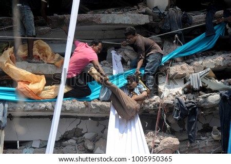 DHAKA, BANGLADESH - APRIL 24, 2013: Rescue workers try rescue trapped garment workers in the Rana plaza building which collapsed in Saver near Dhaka, Bangladesh on April 24, 2013.