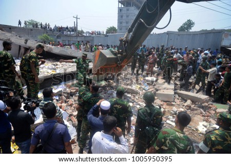 DHAKA, BANGLADESH - APRIL 24, 2013: Rescue workers try rescue trapped garment workers in the Rana plaza building which collapsed in Saver near Dhaka, Bangladesh on April 24, 2013.