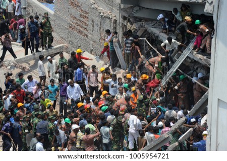 DHAKA, BANGLADESH - APRIL 24, 2013: Rescue workers try rescue trapped garment workers in the Rana plaza building which collapsed in Saver near Dhaka, Bangladesh on April 24, 2013.