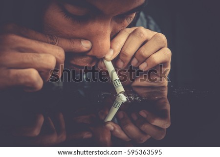 Drugs concept. Closeup picture of drug addict using drugs. Drug addict man alone.