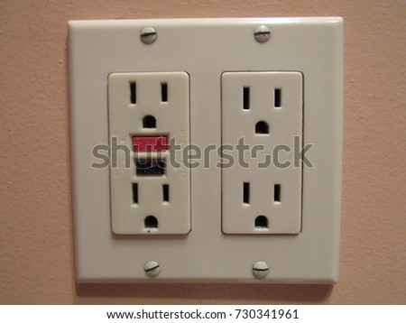 Electrical outlet with reset button