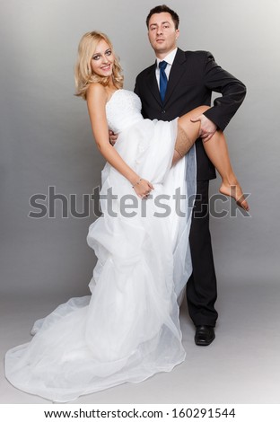 https://thumb7.shutterstock.com/display_pic_with_logo/175351/160291544/stock-photo-wedding-day-portrait-of-happy-married-couple-sexy-blonde-bride-and-groom-in-full-length-studio-160291544.jpg