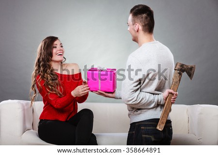 https://thumb7.shutterstock.com/display_pic_with_logo/175351/358664891/stock-photo-sneaky-insincere-man-holding-axe-giving-gift-present-box-to-woman-husband-concealing-hiding-his-358664891.jpg