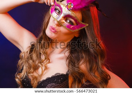 People, fashion, party concept. Sensual woman with carnival mask. Attractive young lady with long brown hair preaparing for celebration.