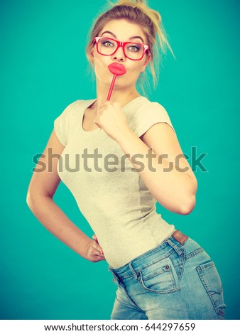 https://thumb7.shutterstock.com/display_pic_with_logo/175351/644297659/stock-photo-lovely-sweet-woman-casual-style-nerdy-glasses-holding-red-fake-lips-on-stick-having-fun-on-green-644297659.jpg