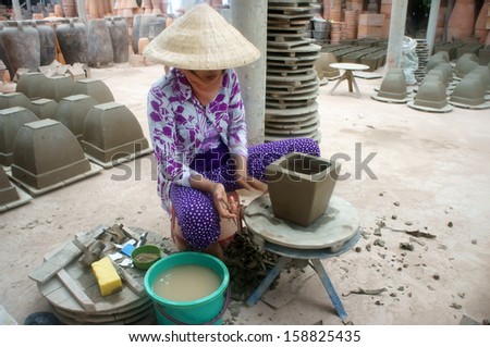 VINH LONG, VIET NAM- JULY 1: Potter form pot at potterry workshop in Vinh Long, Viet Nam on July 1, 2013