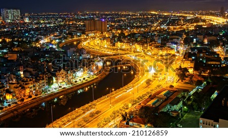 HO CHI MINH ,VIETNAM- AUG 7: Impression landscape of Asia city at night, group of house along Tau hu canal, yellow trail on street, panaromic from high view make colorful scene, Viet Nam,Aug 7,2014