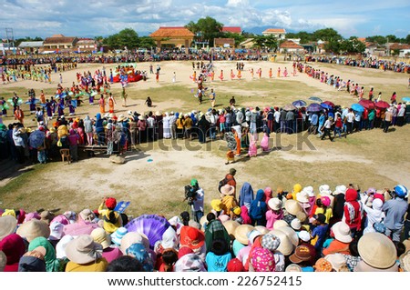 PHAN RANG, VIET NAM- OCT22: Amazing show at public stadium in Kate carnival, crowded panorama, group of Vietnamese woman in tradition clothing, fan dance in music, colorful dress,Vietnam, Oct22, 2014
