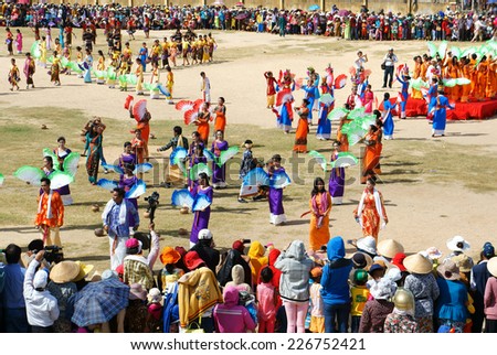 PHAN RANG, VIET NAM- OCT22: Show at public stadium in Kate carnival, crowded panorama, group of Vietnamese woman in tradition clothing, fan dance in music, colorful dress,Vietnam, Oct22, 2014