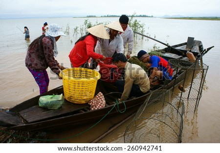 DONG NAI- VIET NAM- AUST 31: Group of Asian fisherman fishing on Tri An lake, a branch of Dong Nai river, crowd of people collect river fish on row boat, Vietnam, Aust 31, 2014