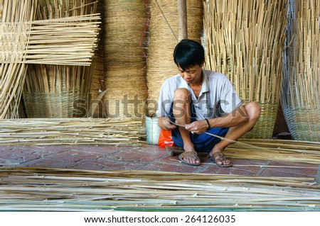 VINH LONG, VIET NAM- MAR 24: Asia trade village at Mekong Delta, Vietnamese people work inside to make basket from bamboo material, clever hand and hard working to make product, Vietnam, Mar 24, 2015