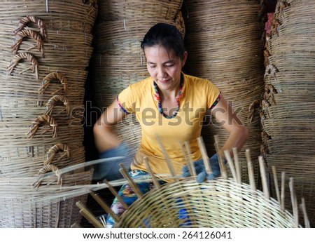 VINH LONG, VIET NAM- MAR 24: Asia trade village at Mekong Delta, Vietnamese people work inside to make basket from bamboo material, clever hand and hard working to make product, Vietnam, Mar 24, 2015