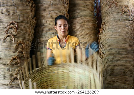 VINH LONG, VIET NAM- MAR 24: Asia trade village at Mekong Delta, Vietnamese people work inside to make basket from bamboo material, clever hand and hard working to make product, Vietnam, Mar 24, 2015