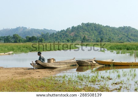 DAK LAK- VIET NAM- JUNE11: Group of Asian farmer go to work by row boat on Lak lake in summertime, family of ethnic minority, grass on lake, amazing view for Asia travel, Daklak, Vietnam, June11, 2015