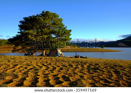 Beautiful panorama landscape at Dalat countryside, Vietnam, amazing wide grass in yellow morning, lake among pine forest, mountain far away, pine tree, wonderful scene for Da Lat, Viet Nam travel
