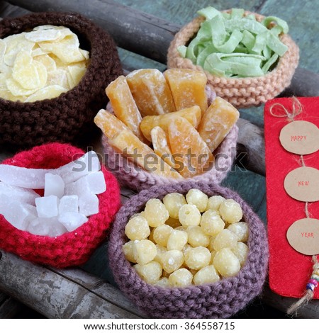 Vietnamese food for Tet holiday in spring, jam is traditional food on lunar new year, can make from sweet potato, lotus seed, ginger with sugar, colorful background for Vietnam custom