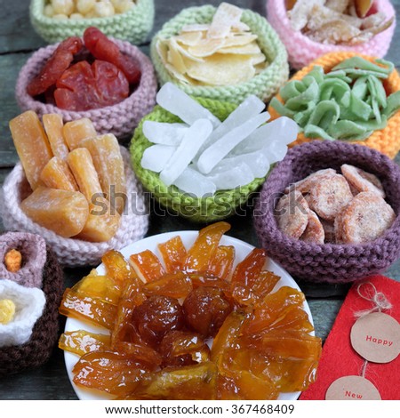 Amazing of Vietnamese food for Tet holiday in spring, jam is traditional food on lunar new year, make from sweet potato, lotus seed, ginger, mango with sugar, colorful background for Vietnam culture