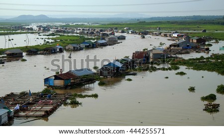 DONG NAI, VIET NAM- JUNE 5: Group of floating house on La Nga fishing village, river with green grass and hyacinth, residence of people who live with fish farming at Dongnai, Vietnam