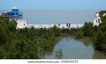 CA MAU, VIET NAM- JULY 16, 2016: Group of tourist travelling Dat Mui, a geography place people walking on breakwater along the beach
