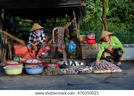 CA MAU, VIET NAM- JULY 15, 2016: Roadside food stalls, outdoor fish market at Mekong Delta countryside, vendor sell seafood as fish, oyster, shrimp, Camau, Vietnam