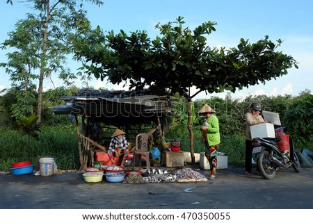 CA MAU, VIET NAM- JULY 15, 2016: Roadside food stalls, outdoor fish market at Mekong Delta countryside, vendor sell seafood as fish, oyster, shrimp, Camau, Vietnam