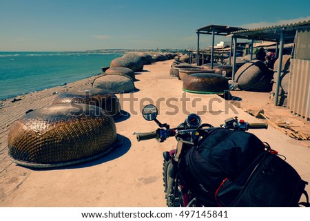 Backpacker trip to adventure Vietnam beach by motorcycle in summertime, Binh Thuan fishing village with group of coracle along the way, motorbike stop to relax