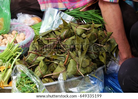 Vietnamese traditional food for may 5th, is double five festival or tet doan ngo, group of sticky rice cake in green leaf, also call banh u tro with pyramidal shape at open air market
