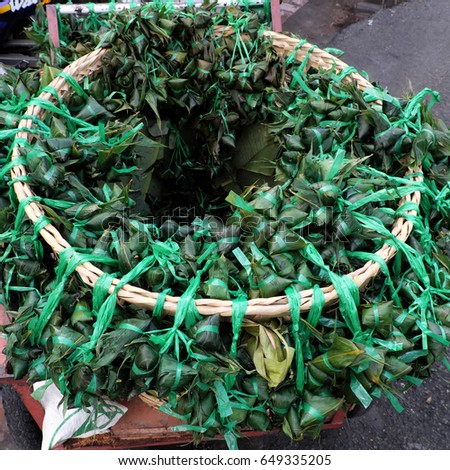 Vietnamese traditional food for may 5th, is double five festival or tet doan ngo, group of sticky rice cake in green leaf, also call banh u tro with pyramidal shape at open air market