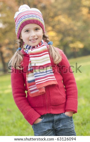 Little girl in autumn park