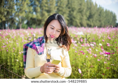 https://thumb7.shutterstock.com/display_pic_with_logo/1771481/548239885/stock-photo-asian-girl-playing-phone-cosmos-flower-garden-548239885.jpg