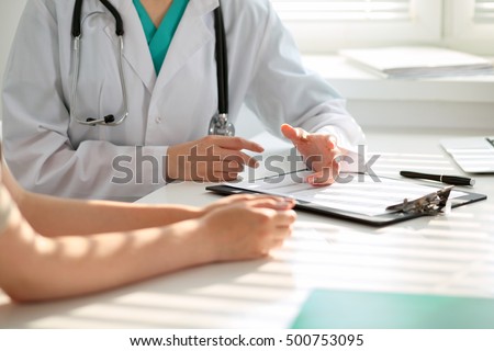 Doctor and patient are discussing something, just hands at the table